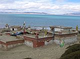 Tibet Kailash 07 Manasarovar 01 Seralung with lake in background We drove the Lake Manasarovar Kora in one day, following dirt roads around the lake and stopping at monasteries en route. Our first stop on the Kora was at Seralung Gompa, at the northeast corner of the lake. Some of the Gompa�s religious property, thrown into the lake during the Cultural Revolution, has been recovered. The Gompa was rebuilt in 1984. Guru Rinpoche (Padmasambhava) and Shakyamuni are the main images, and colourful masks adorn the shrine.